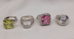 Four Stamped Sterling Silver Lady's Simulated Gemstone Rings with a Bright Polish Finish.