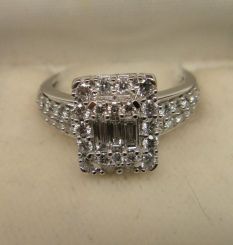 One stamped 14KT white gold lady's cast diamond ring with a bright polish finish. Containing: Three prong set baguette cut diamonds, measuring from 4.20 x 1.50 x 1.28mm (depth est.) to 4.30 x 1.60 x 1.36mm (depth est.) approximate total weight o