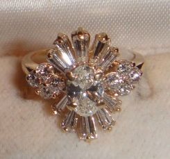 One 14KT yellow gold lady's cast diamond dinner ring with a tapered flat shank with a bright polish finish. Containing: One prong set oval shaped cut diamond, measuring 7.00 x 5.02 x 2.89mm (depth est.) approximate weight of 0.65ct. Clarity- SI-