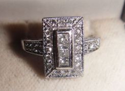 One pair stamped 14KT white gold lady's cast three diamond ring with a bright polish finish. Containing: Three channel set princess cut diamonds, measuring 2.80 x 2.50 x 1.88mm (depth est.) approximate total weight of 3 Stones= 0.32ct. Clarity- 