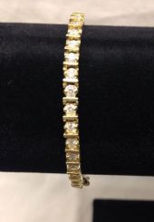 One stamped 14KT yellow gold lady's cast diamond tennis bracelet with a 14 kt yellow gold clasp with a bright polish finish. Containing: Forty-two prong set round brilliant cut diamonds, measuring 2.90 - 2.75 x 1.70mm (depth est.) approximate to
