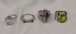Four Stamped Sterling Silver Lady's Simulated Gemstone Rings with a Bright Polish Finish.