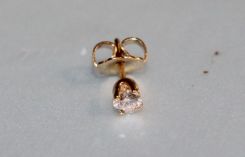 One stamped 14KT yellow gold lady's die struck diamond stud earring with friction post with nut backs with a bright polish finish. Containing: One prong set round brilliant cut diamond, measuring 3.20- 3.18 x 1.91mm (depth est.) approximate weig