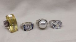 Four Stamped Sterling Silver Lady's Simulated Gemstone Rings with a Bright Polish Finish.