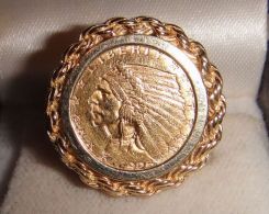 One 21KT and 14KT yellow gold lady's combination cast & die struck coin ring with a rope border filigree shank with a bright polish with relief finish. The coin was minted in 1925. The coin is a 2 1/2 dollar 