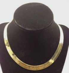 One stamped 10KT yellow gold lady's cast 11mm wide and 16