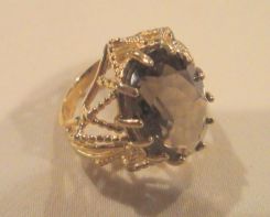 One stamped 14KT yellow gold lady's cast smoky quartz ring with a filigree shank with a bright polish with filligree accents finish. Containing: One prong set oval standard brilliant cut natural smoky quartz, measuring 18.00 x 13.10 x 7.30mm, 12