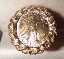 One 22KT and 10KT yellow gold lady's combination cast & die struck gold coin ring with a rope border filigree shank with a bright polish with relief finish. The coin was minted in 1996. The coin is a 1/10 oz. 