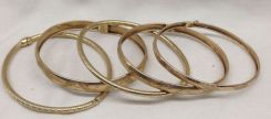 Five stamped 10KT yellow gold lady's Bangle bracelets with a varying finish. Total Weight of Bracelets 13.70 dwt
